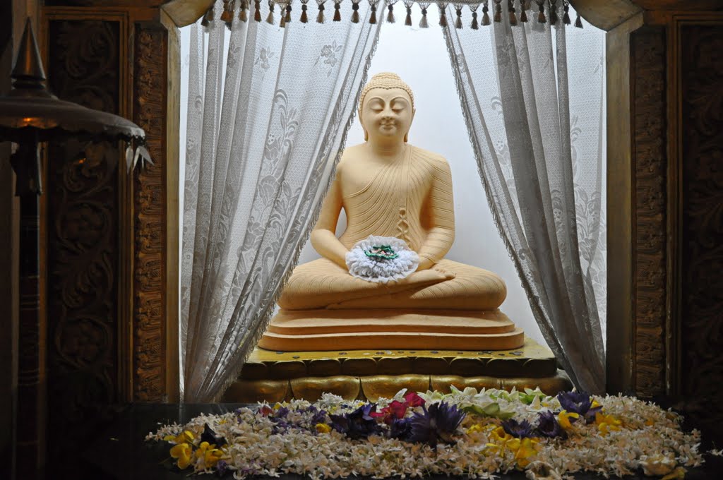 Цветы у статуи будды