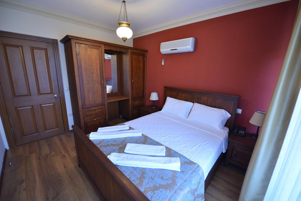Спальня в апарт-отеле Dores Residence